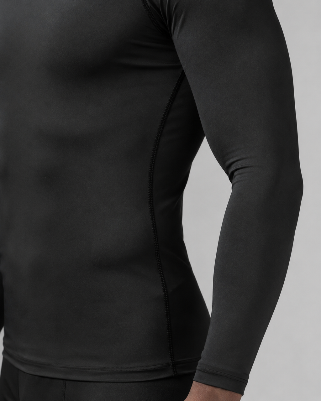 Black long sleeve athletic compression shirt angled studio product photo