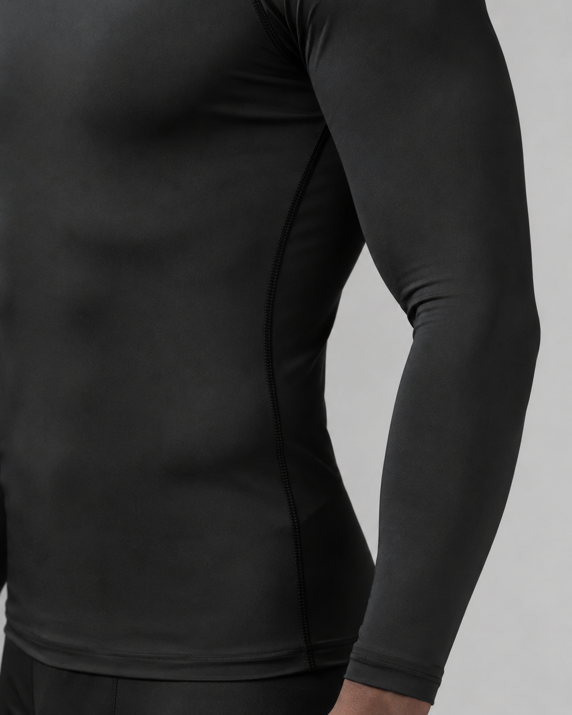 Black long sleeve athletic compression shirt angled studio product photo
