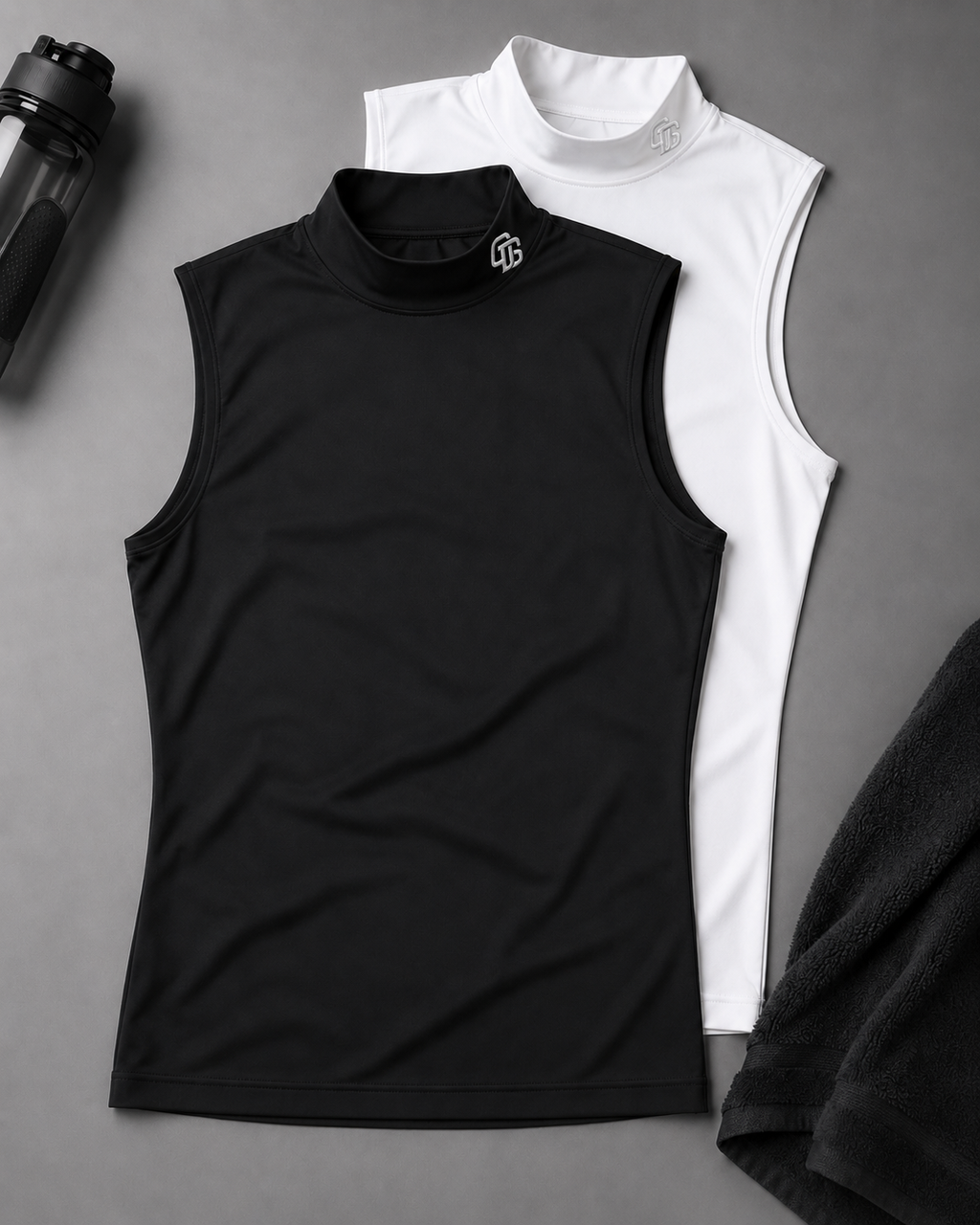 Black sleeveless shirt and white high-neck shirt on a gray surface with a black towel and water bottle.