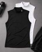 Black sleeveless shirt and white high-neck shirt on a gray surface with a black towel and water bottle.
