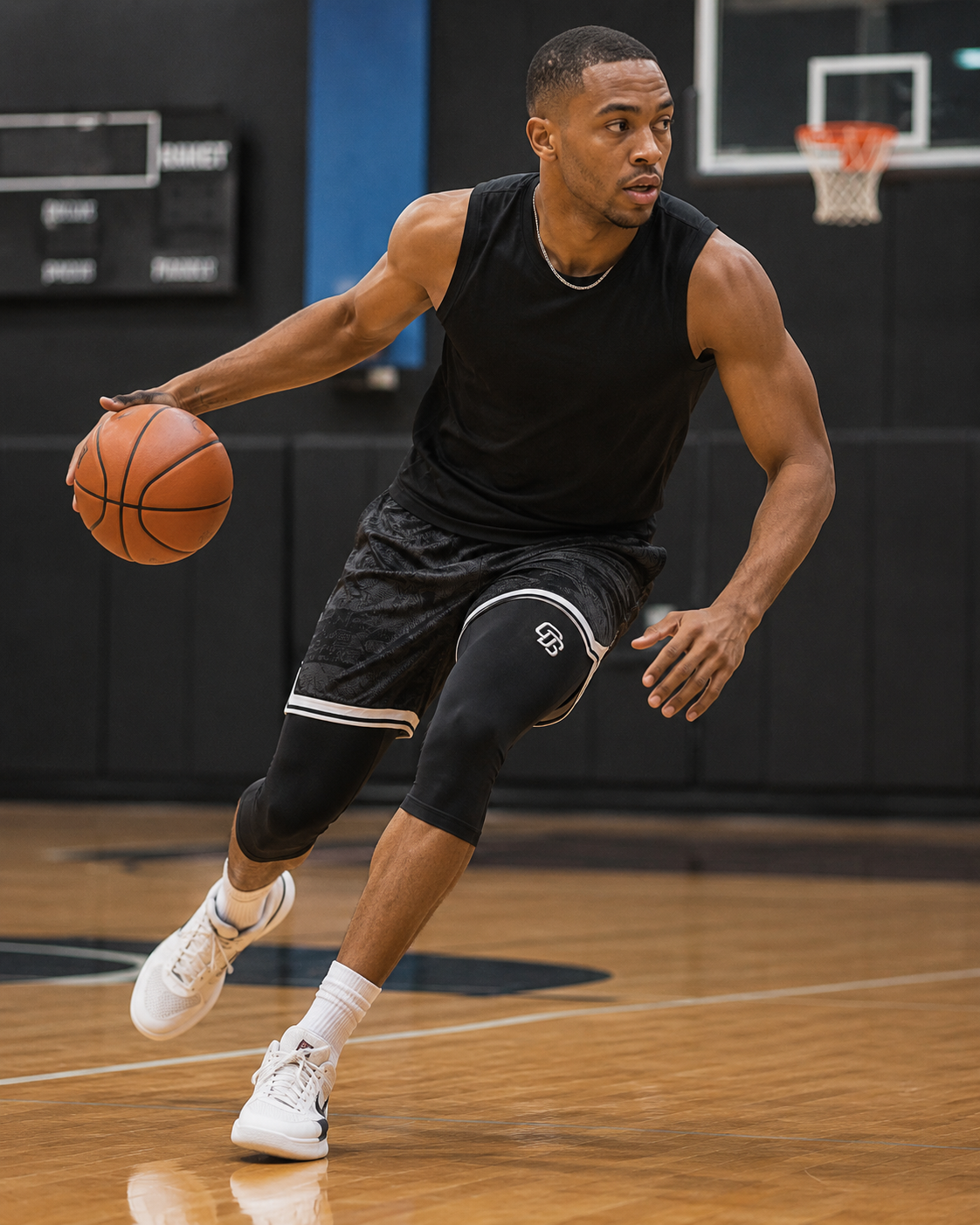 Man in black athletic wear dribbling a basketball on a court