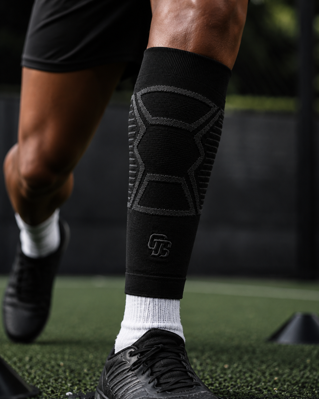 Person wearing a black compression sleeve on a sports field