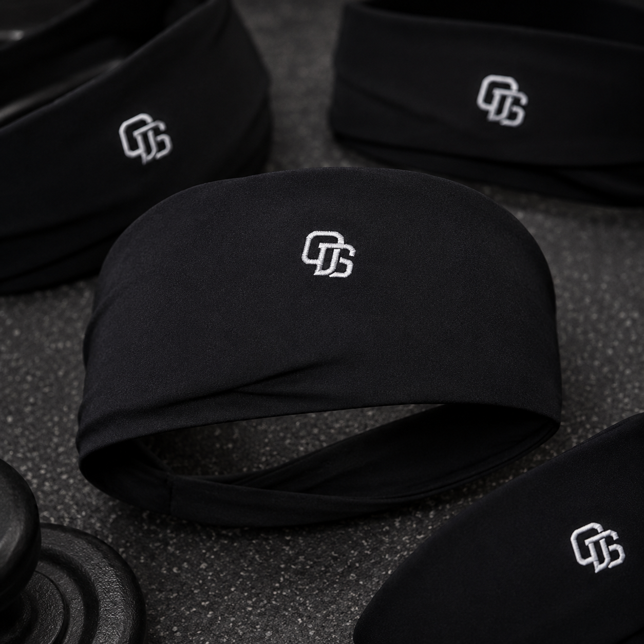 Black headbands with a logo on a textured surface