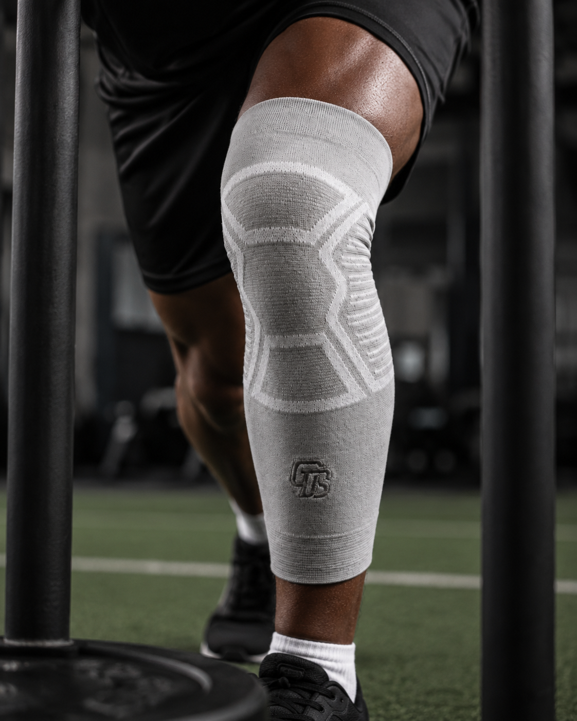 Person wearing a gray knee brace on a sports field