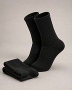 Pair of black socks on a light gray background