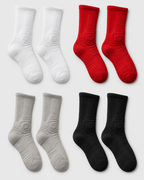Set of white, red, gray, and black socks on a light gray background