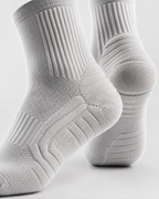 Gray socks with textured pattern on a light gray background