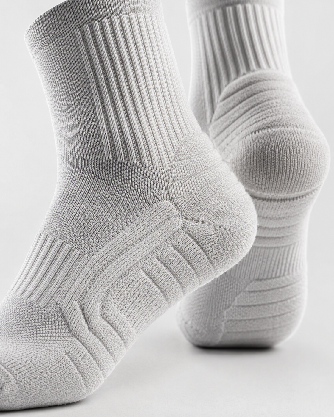 Gray socks with textured pattern on a light gray background